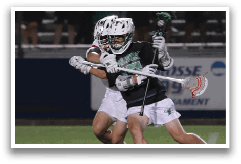 A man in a white and green uniform holding a lacrosse stick. Description generated by AI