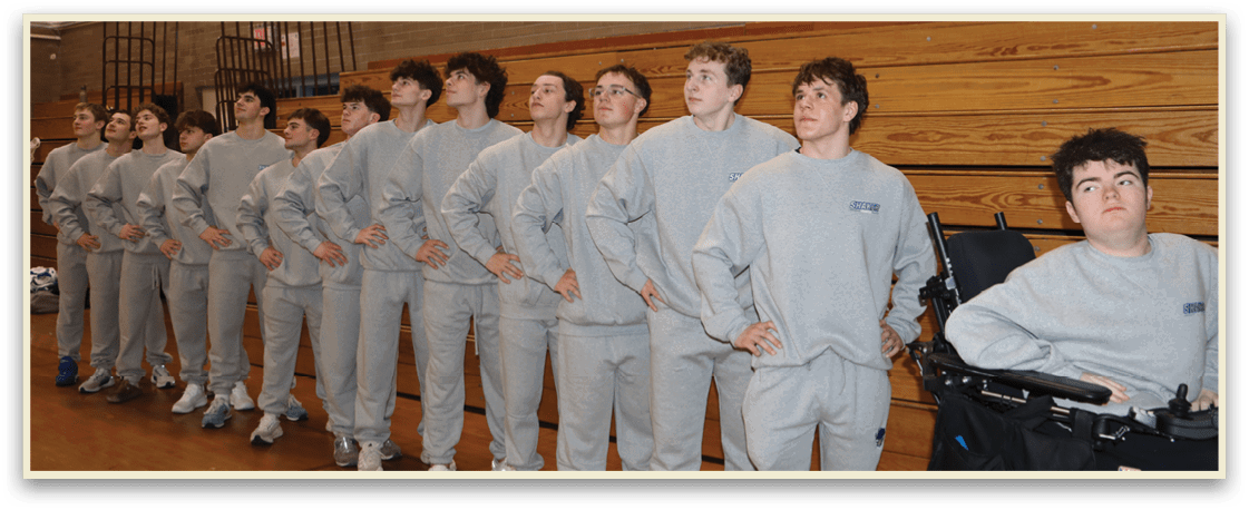 A group of young men wearing grey sweatshirts and white sneakers are standing in a line. AI generated content