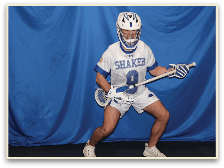 A man wearing a white and blue uniform is holding a lacrosse stick. AI generated content