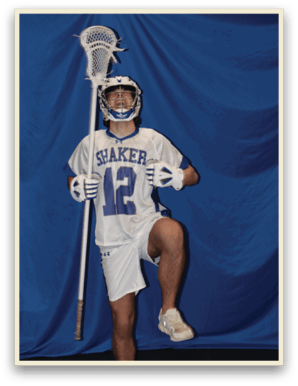 A man wearing a white jersey with the number 12 holds a lacrosse stick. AI generated content