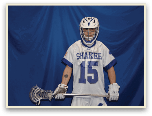 A man wearing a white and blue jersey with the number 15 stands in front of a blue curtain holding a lacrosse stick. AI generated content