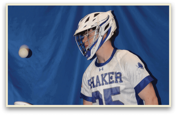 A man wearing a white and blue jersey holds a lacrosse stick. AI generated content