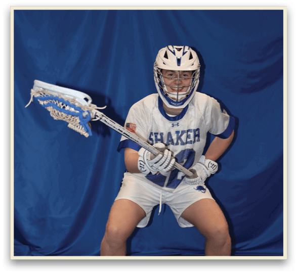 A man is sitting on the ground holding a lacrosse stick. AI generated content