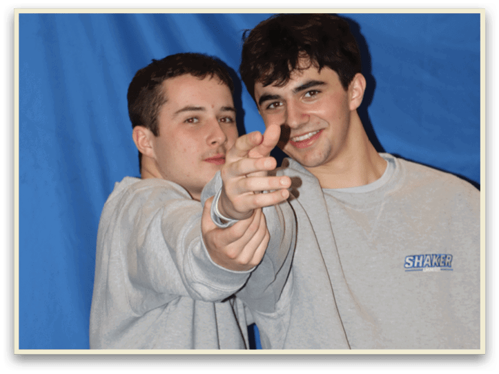 Two men wearing gray sweat suits are pointing their fingers at the camera. AI generated content