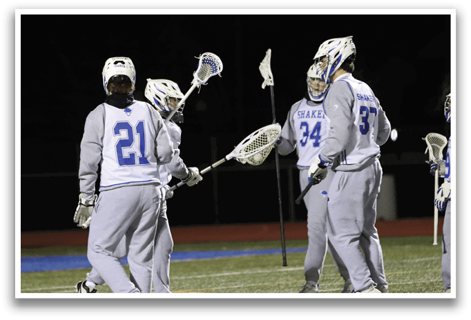 Three lacrosse players wearing grey uniforms and holding their sticks. AI generated content