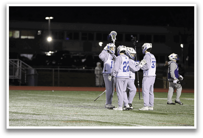 A group of young men are standing on a field, holding their lacrosse sticks. AI generated content
