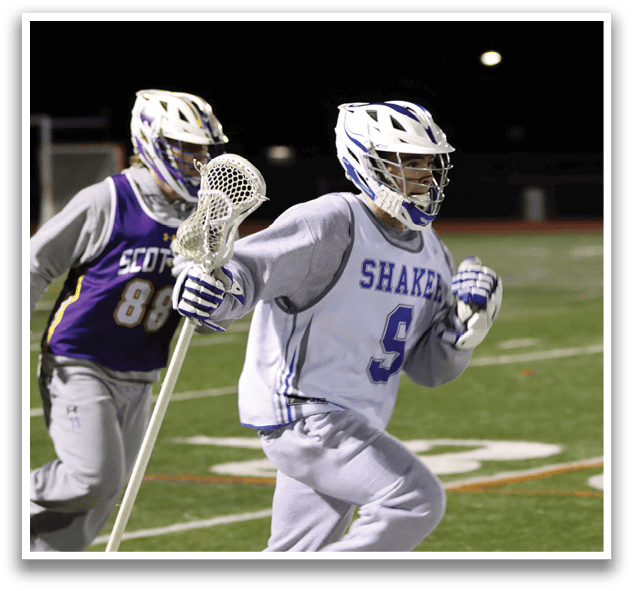 Two men are running on a field, one holding a lacrosse stick. AI generated content