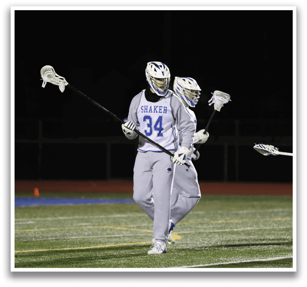 Three men are playing lacrosse on a field. One of them is holding a stick. AI generated content