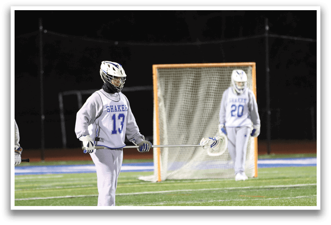 Three people are standing on a field, two of them holding lacrosse sticks. AI generated content