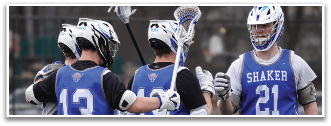 Three lacrosse players wearing blue uniforms and white helmets are standing on a field. They are holding their lacrosse sticks and appear to be talking to each other. AI generated content