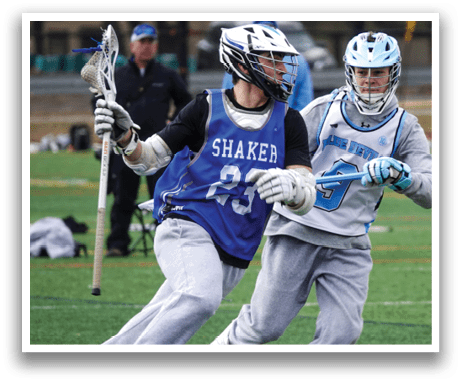 Two men playing lacrosse on a field. One man is wearing a blue jersey with the number 23. AI generated content