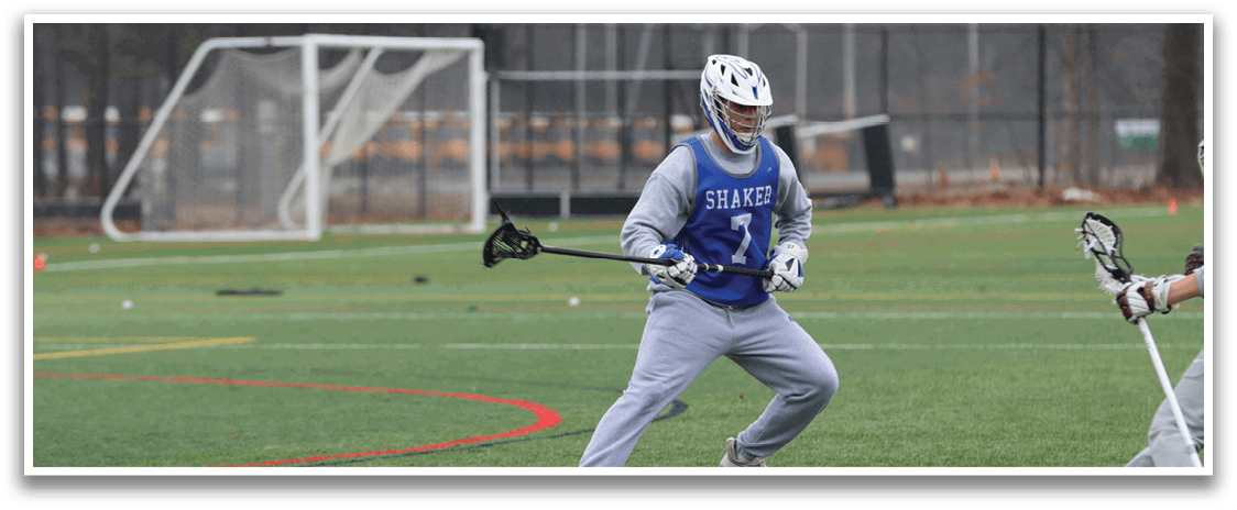 Three people are playing a game of lacrosse on a field. One person is holding a lacrosse stick, while the other two are running towards the goal. AI generated content