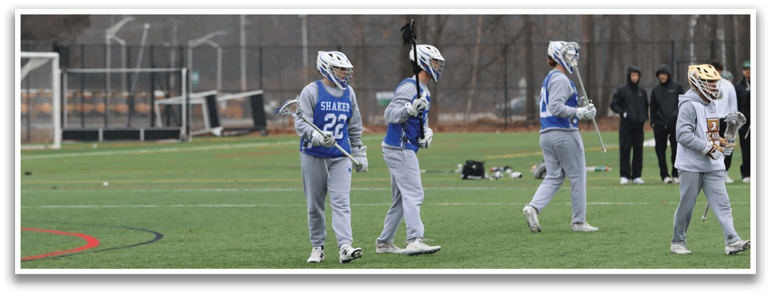 A group of people are playing a game of lacrosse on a field. AI generated content