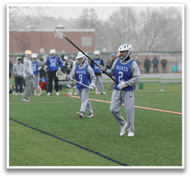 A group of people are playing a game of lacrosse on a field. AI generated content