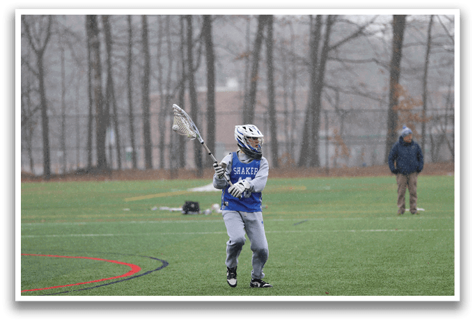 A person holding a lacrosse stick on a field. AI generated content