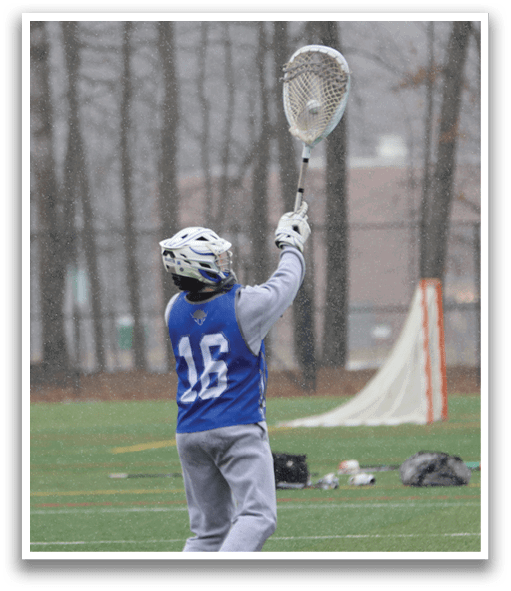 A person wearing a blue and white uniform is holding a lacrosse stick and preparing to catch a ball. AI generated content