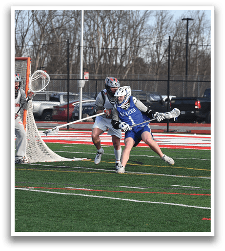 A man in a blue shirt is running towards a goal while holding a stick. AI generated content