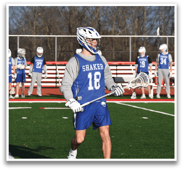 A group of people are standing on a field, some of them holding lacrosse sticks. AI generated content