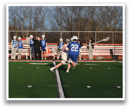 A group of people are playing a game of lacrosse on a field. AI generated content