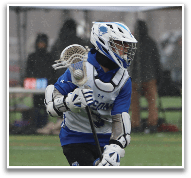 A man wearing a blue and white uniform is running with a lacrosse stick in his hand. AI generated content