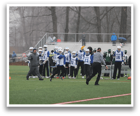 A group of people are playing a game of lacrosse on a field. AI generated content