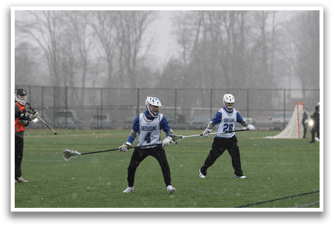 Three men are playing a game of lacrosse in the snow. AI generated content