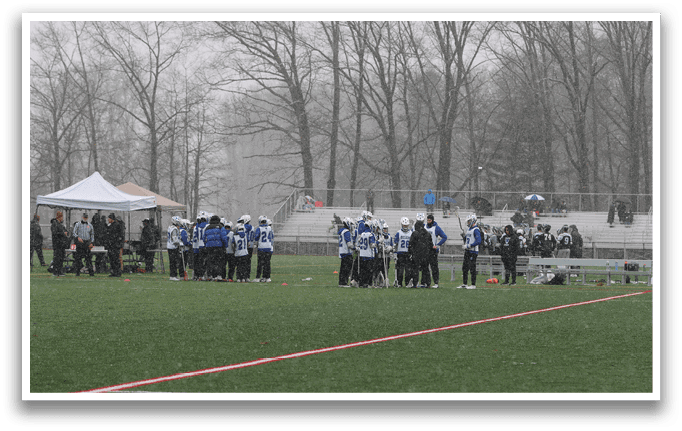 A group of people are standing on a field, some of them holding umbrellas. AI generated content