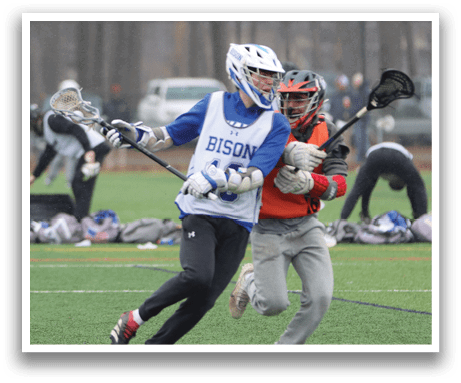 Two people playing lacrosse on a field. One person is holding a lacrosse stick and the other is holding a stick with a net. AI generated content