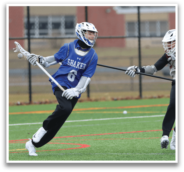 Two lacrosse players are running on a field, one wearing a blue shirt and the other wearing a red shirt. AI generated content