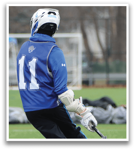 A person wearing a blue and black jersey is holding a baseball bat and standing on one leg. AI generated content