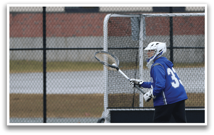 A person in a blue shirt and black pants is playing a game of lacrosse. AI generated content
