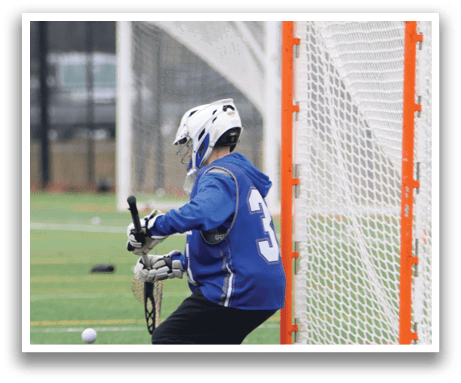 A man wearing a blue shirt and black pants is playing a game of lacrosse. He is holding a lacrosse stick and is positioned in front of a net. AI generated content
