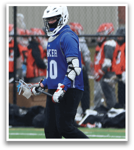 A man wearing a blue and white jersey walks across a field while holding a lacrosse stick. AI generated content