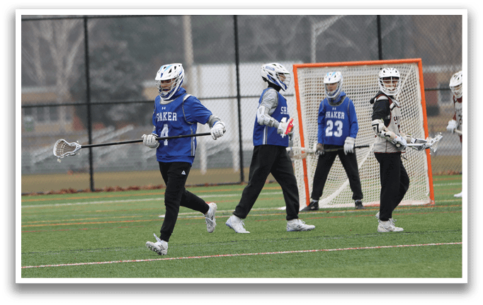 A group of young men are walking across a field, each holding a lacrosse stick. AI generated content