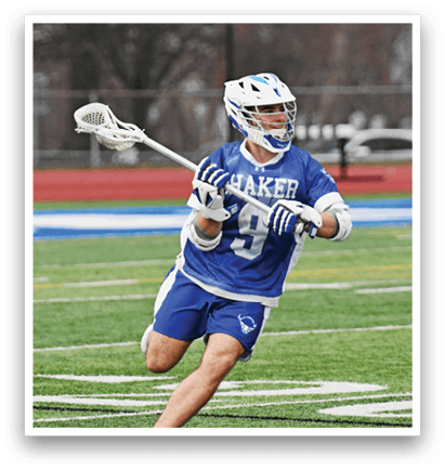 A man wearing a blue and white uniform is running on a field while holding a lacrosse stick. AI generated content