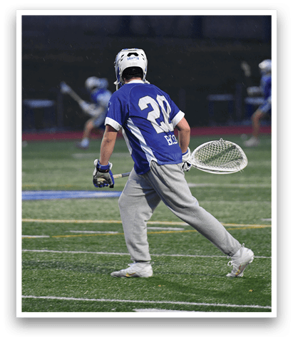 A man in a blue and white uniform is holding a tennis racket on a field. AI generated content