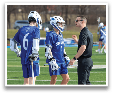 Three men wearing blue and white uniforms are standing on a field. One man is talking to the other two, who are wearing helmets. They are all holding baseball bats. AI generated content