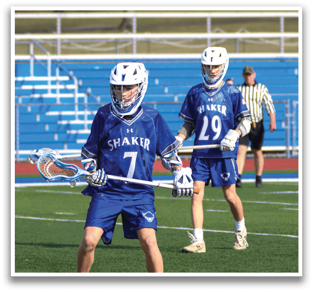 Two young men playing lacrosse on a field. AI generated content