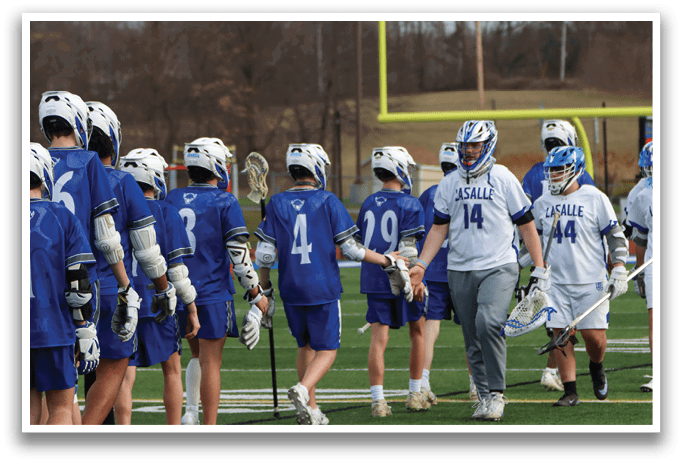 A group of lacrosse players wearing blue uniforms are walking across a field. AI generated content