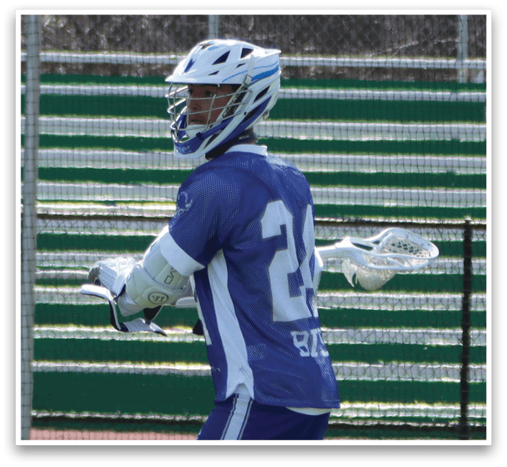 A man wearing a blue and white jersey is holding a lacrosse stick and walking on a field. AI generated content