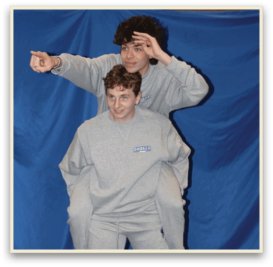 Two people are posing for a picture, one is holding the other's legs. AI generated content