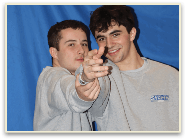 Two men wearing gray sweat suits are pointing their fingers at the camera. AI generated content