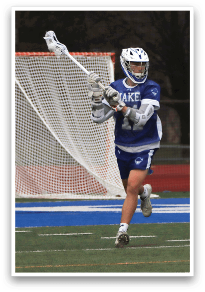 A man in a blue and white uniform is holding a lacrosse stick and running on a field. AI generated content