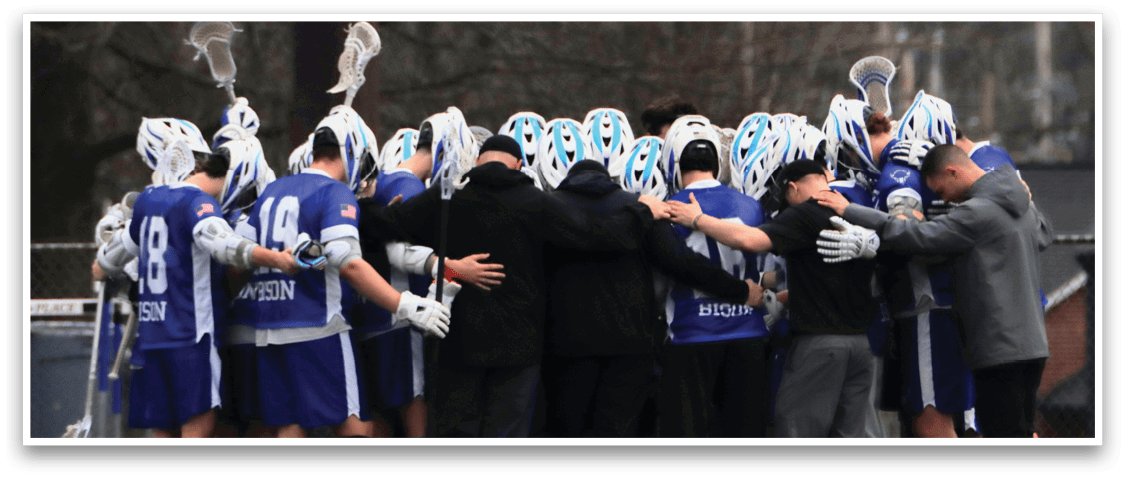 A group of people wearing blue and white uniforms huddle together on a field. AI generated content