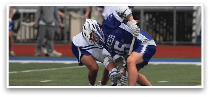 Two boys playing a game of lacrosse on a field. AI generated content