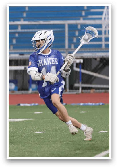 A person wearing a blue and white shirt and white socks is holding a lacrosse stick. AI generated content