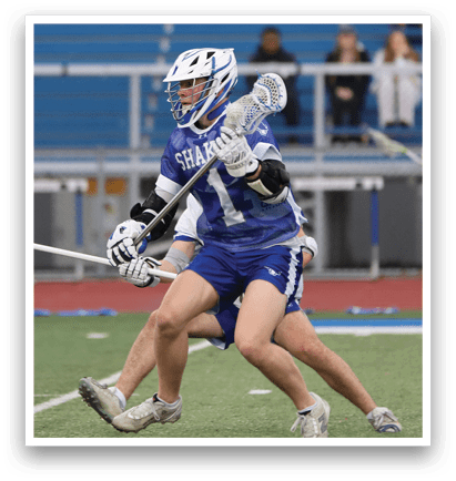 A man wearing a blue and white uniform is playing lacrosse. He is holding a stick and appears to be running towards the ball. AI generated content