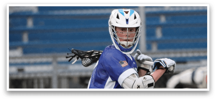 A young man wearing a blue and white uniform is playing lacrosse. He is holding a lacrosse stick and preparing to shoot the ball. AI generated content
