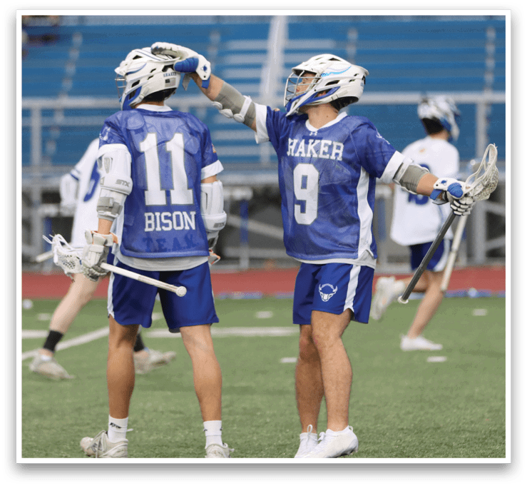Two male lacrosse players from opposing teams are high-fiving each other on the field. AI generated content