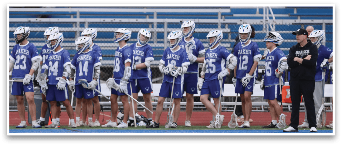 A group of young men wearing blue and white uniforms are standing on a field. AI generated content